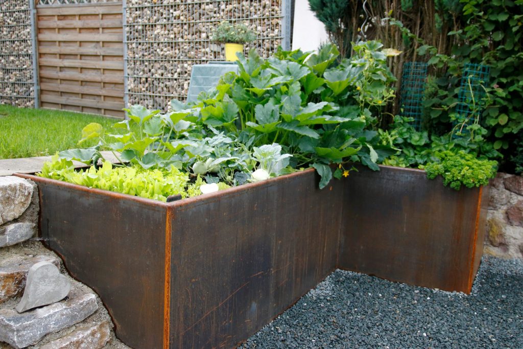 L Shaped corten steel planter with plants