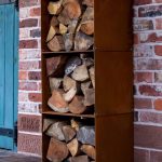 3 corten steel log store boxes stacked vertically with logs in
